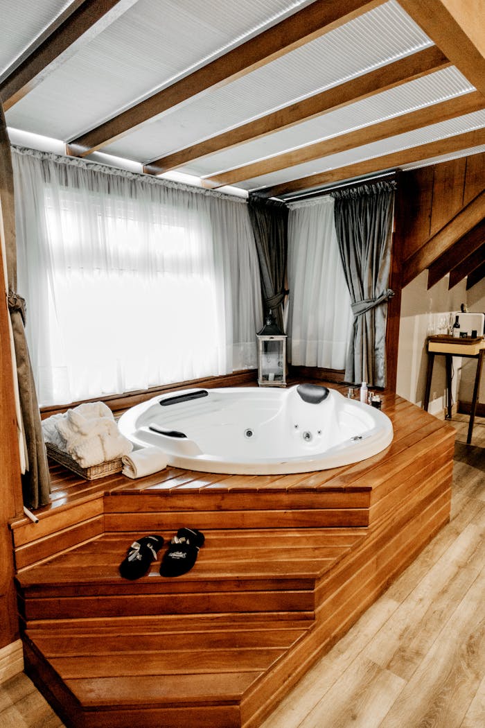 mission-02 Elegant indoor spa featuring a modern wooden bathtub with luxurious amenities, perfect for relaxation.