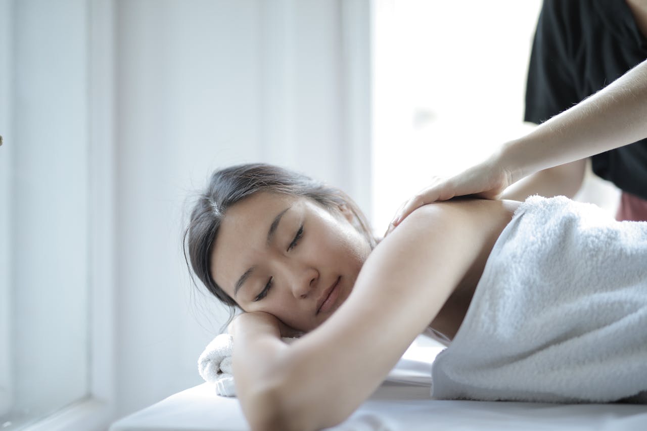 about-07 Asian woman enjoying a relaxing body massage at a spa to unwind and rejuvenate.