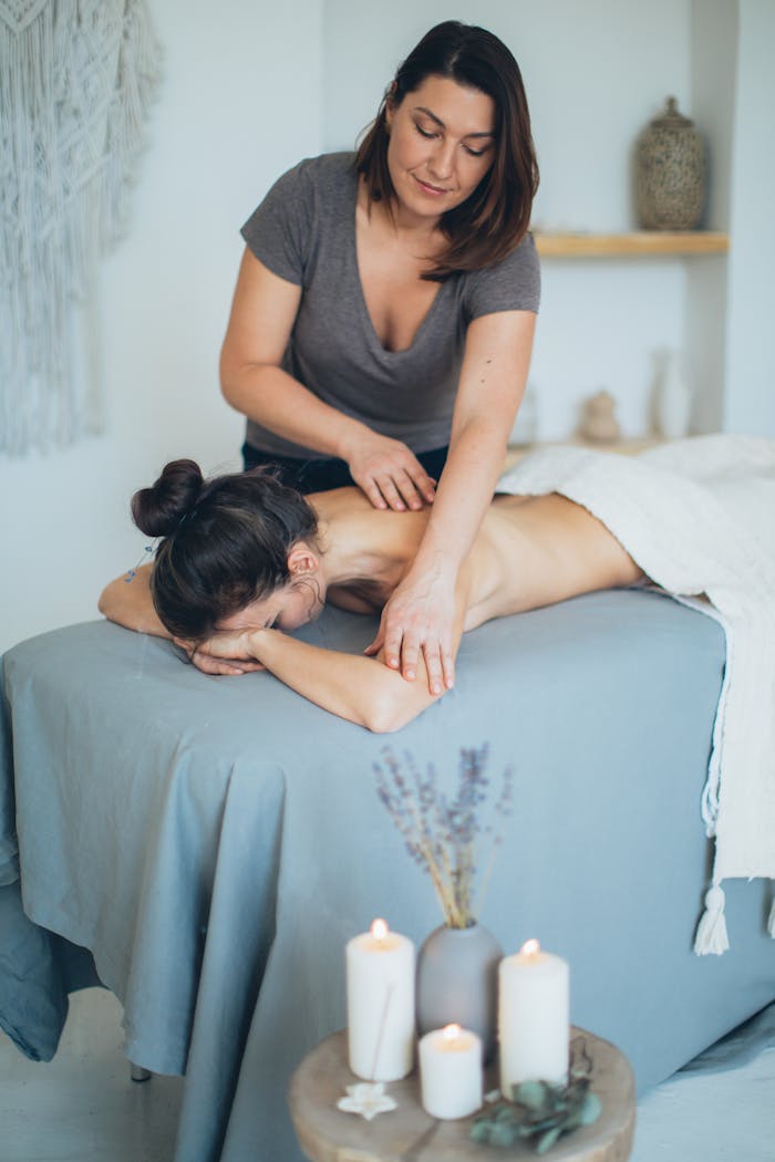 about-05 A serene spa setting with a therapist giving a back massage to a female client for relaxation.